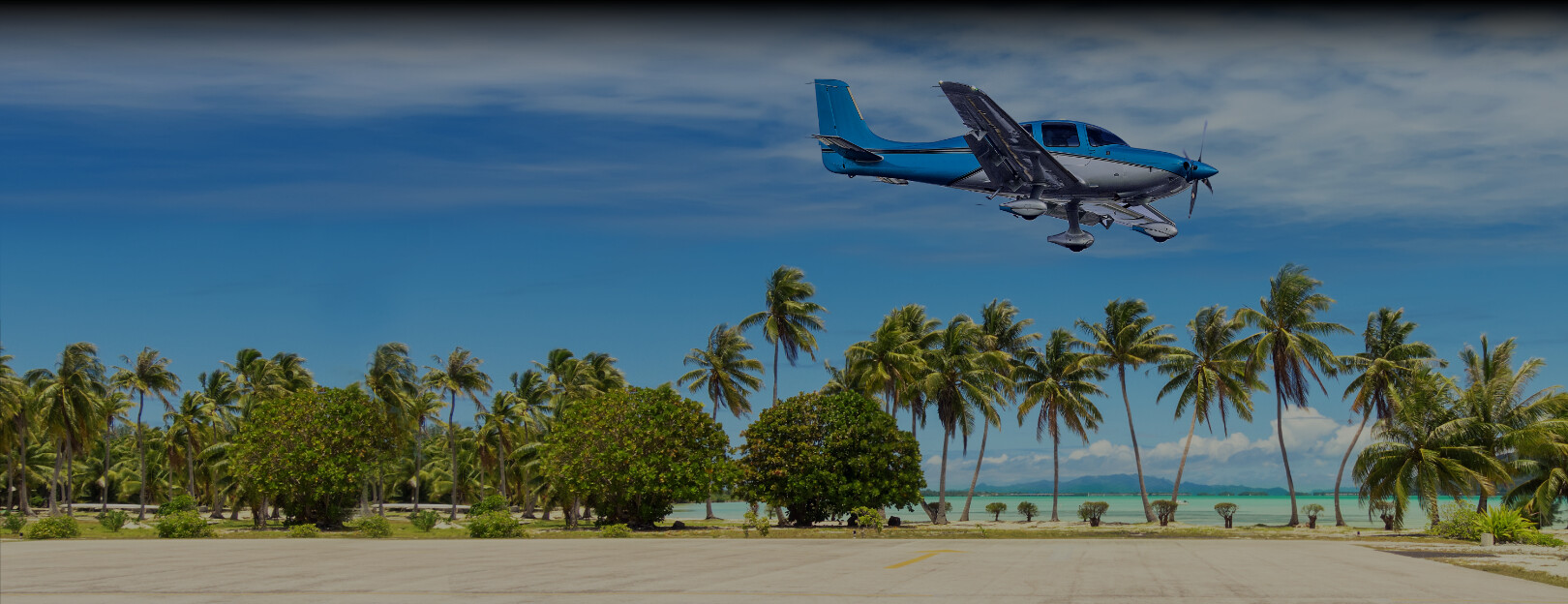 Cirrus aircraft landing near a tropical beach