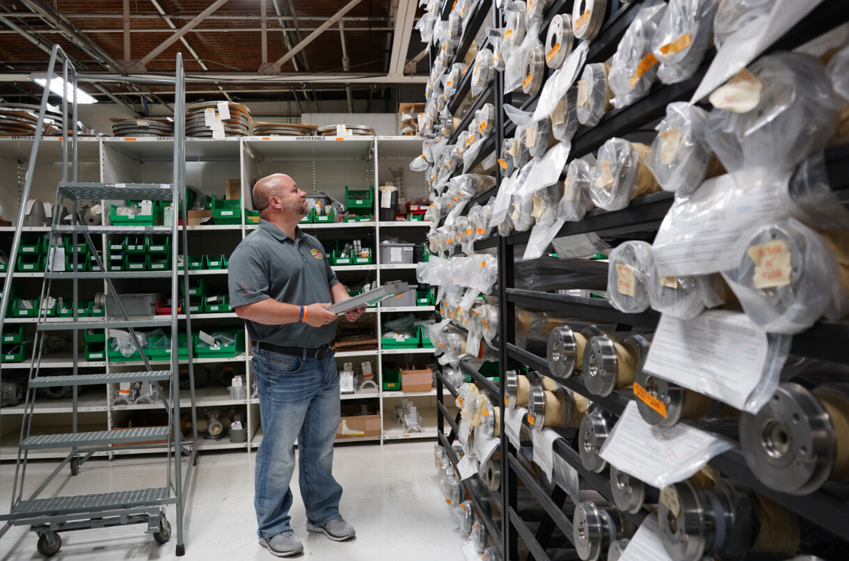 Hartzell Propeller technician looks over stock of propellers on shelves