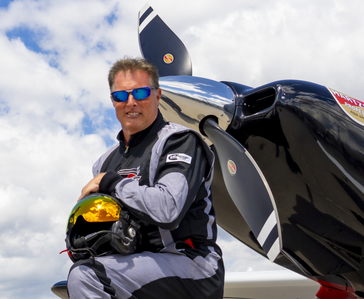 Ken Reider posing next to a Hartzell Propeller on his aircraft